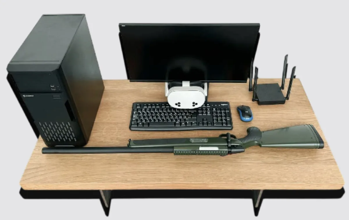 VR trainer station with a PC, monitor, headset and shotgun-style controller