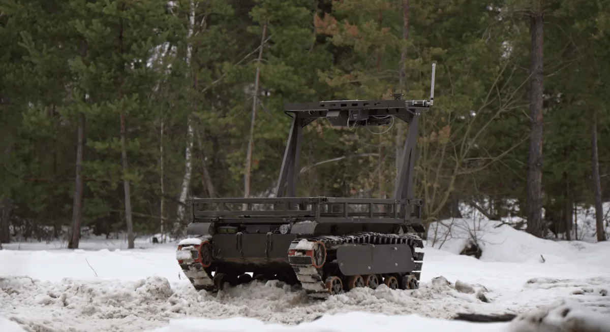 BIZON-L tracked ground robot with a cargo frame in a snowy forest