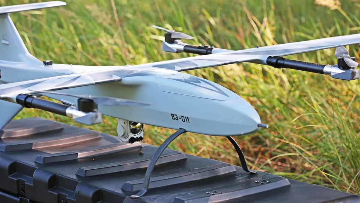 Buntar-3 vertical take-off reconnaissance drone resting on its transport case in tall grass