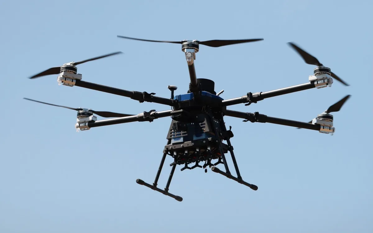 KAZHAN E630 heavy hexacopter in flight against a blue sky