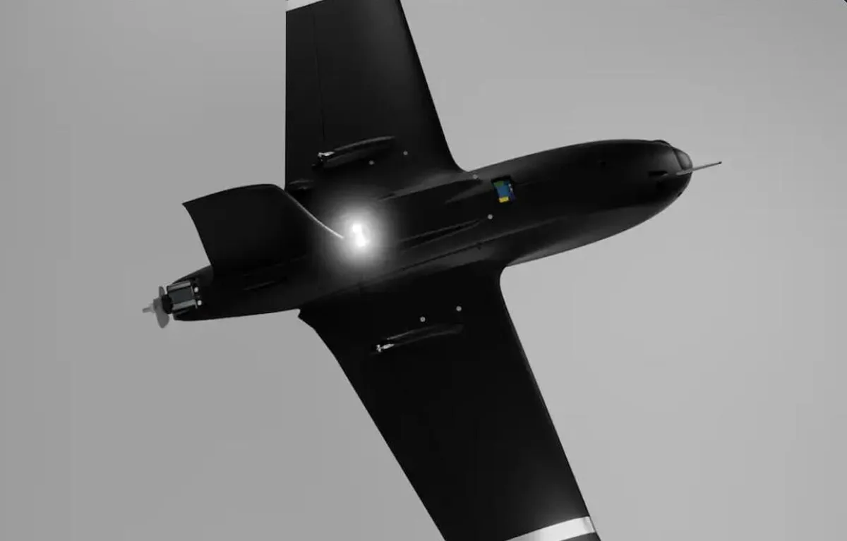 Black fixed-wing interceptor drone in flight