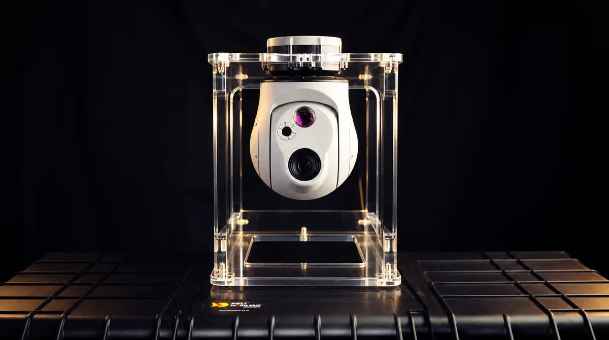 M-Fly gyro-stabilized gimbal camera in a clear display stand