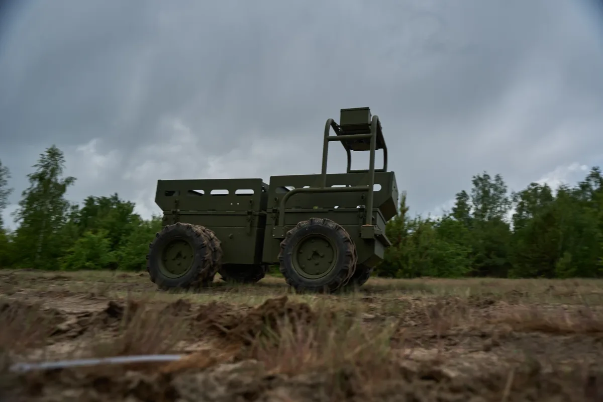 TAUREX olive-green four-wheel logistics robot on a dirt field